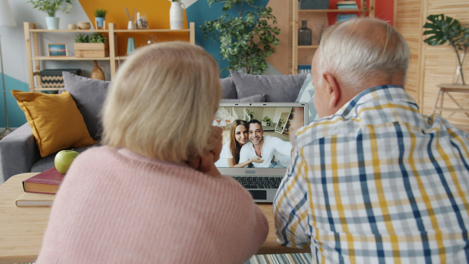 Elderly couple video calling with family at home.